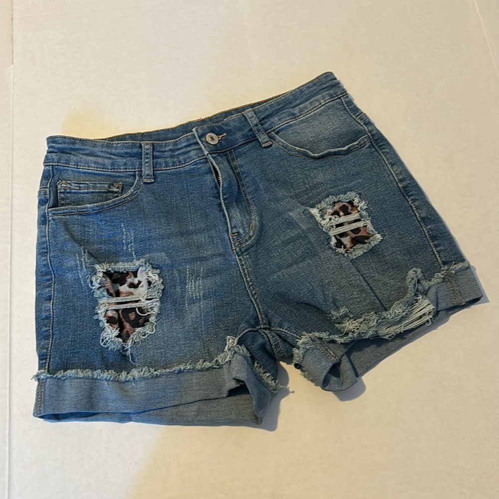 Stretch denim jean shorts with distressed and peek through Cheetah Print